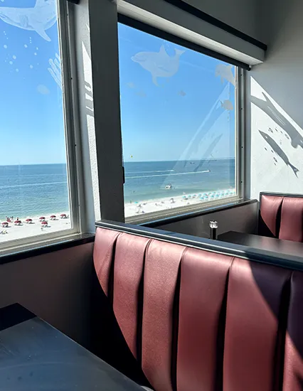 Island View. Indoor booth seating with large windows overlooking Fort Myers Beach and the Gulf of Mexico at Island View restaurant.
